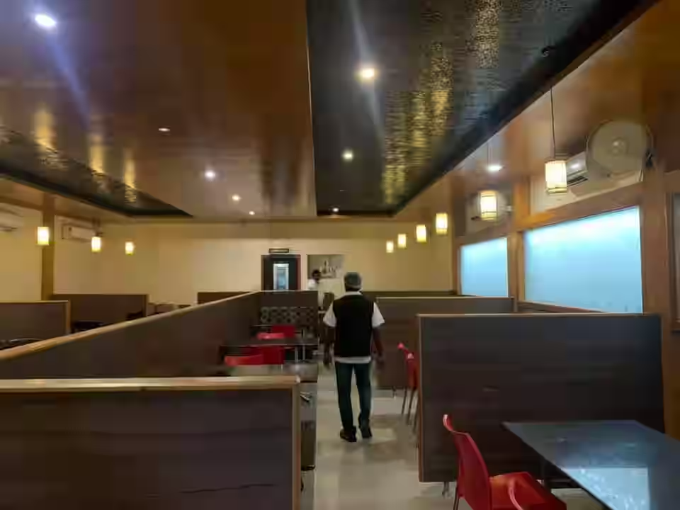 Wood-panelled dining hall with booth seating